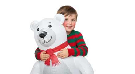 Young boy hugging a large inflatable polar bear wearing a red scarf on a black studio background