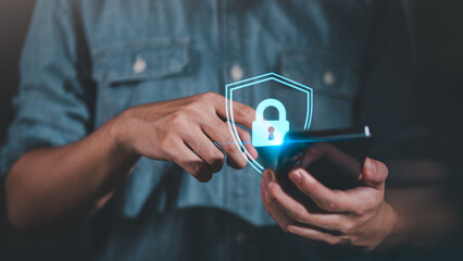 A person using smartphone with glowing padlock icon, representing mobile cybersecurity, encrypted...