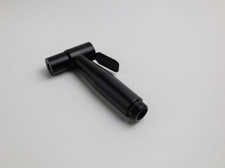 Black jet shower and stainless steel hose on white background