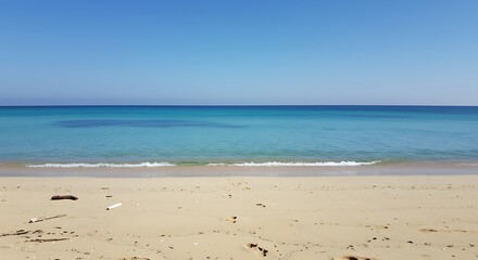 Obraz premium Serene Beachscape: Witness the expansive beauty of a beach meeting the vast sky, with turquoise water gently caressing the golden sands, creating a perfect panorama of tranquility. 