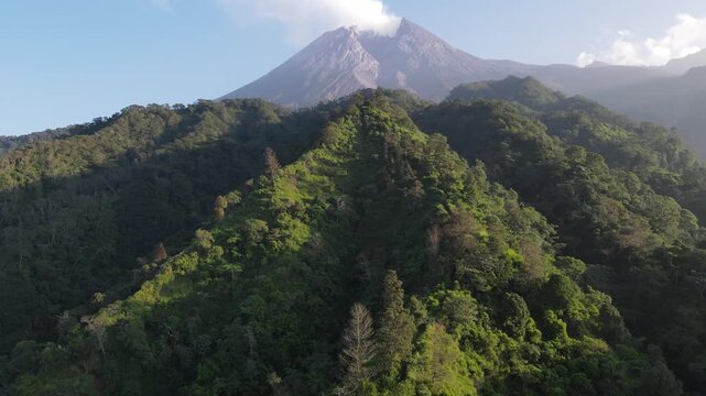 4K Aerial Footage of Mount Merapi at Sunrise with Rays of Light and Clear Blue Sky &ndash; Tranquil Volcanic Landscape in Indonesia