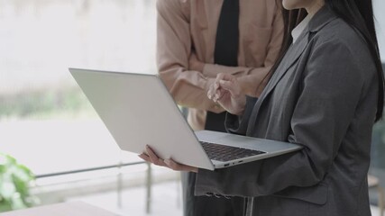 Asian businesswoman explaining document on blank white tablet in conference room using computer, talking, discussing and solving business problems faced.