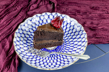 Dark chocolate fudge cake with candied roselle hibiscus calyxes on top
