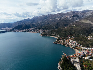 Aerial view of island hotel connected by causeway to coastal village in Montenegro on Adriatic Sea....