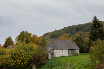 Old peasant house in natural surroundings.Autumn landscape