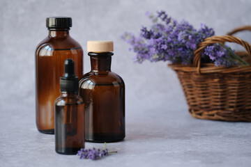 Natural beauty product amber glass bottles filled with lavender essential oil with fresh lavender sprigs. Alternative medicine, organic cosmetics, self-care routine and well-being concept. 