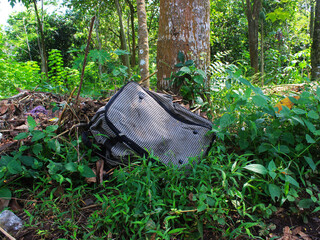 View of a bag abandoned in the forest.