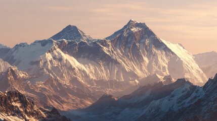 Fototapeta premium Majestic snow-covered mountain range at dawn, bathed in warm, golden light, vast panorama