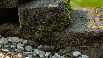 crushed aggregate and dirt shown behind a retaining wall to help manage drainage and reduce hydrostatic pressure. construction and erosion control concept.