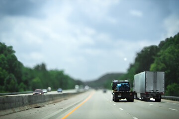 moderate traffic flow on an interstate highway with domestic and commercial vehicles on a summer...