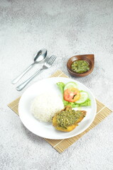 Green chili smashed fried chicken is a common and popular dish in Indonesia.