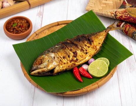 A high resolution, aesthetic still life photograph of ikan asap smoked fish