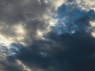 Dark rain cloud dramatic sky summer tropical thunder storm sky and fluffy black darkness cloud nearly raining cloudscape. Nimbus raincloud skyline climate background. Dark gray sky cloudy environment