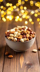 Bowl of mixed nuts on a wooden table with blurred lights