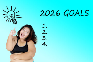 Cheerful overweight woman pointing at 