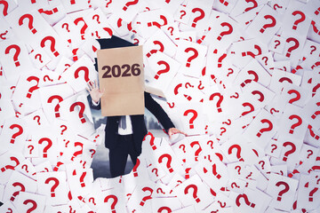 Confused businessman with a box on his head with 2026 text, surrounded by question marks.