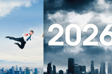 Businessman fighting against the coming year 2026
