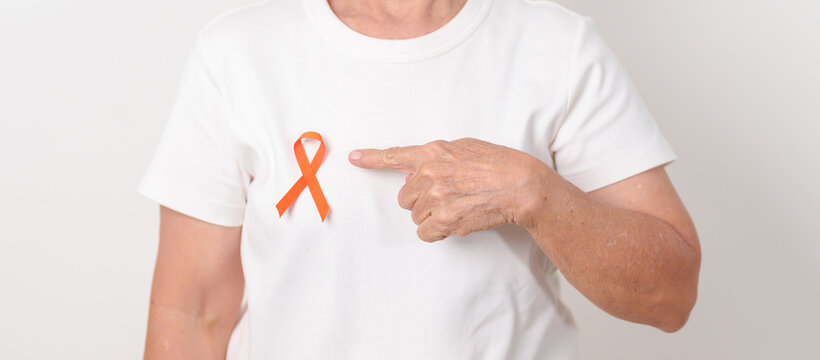 Elderly with Orange Ribbon for September Leukemia, March Kidney cancer day, Multiple Sclerosis, November Complex Regional Pain Syndrome, CRPS, COPD, Chronic Obstructive Pulmonary disease concepts