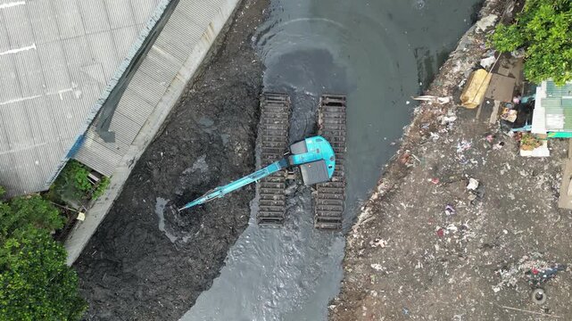 river dredging using heavy equipment in the middle of a residential area