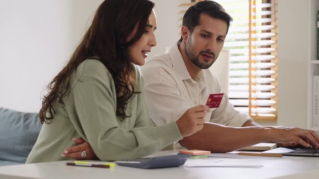 Couple using tablet and credit card to shop online through e-commerce app, making payment and browsing modern platform with promo codes and discount offers
