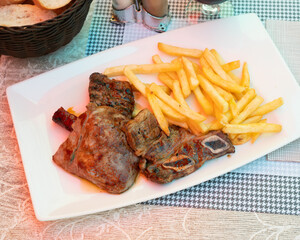 On plate was juicy slice of grilled beef with delicious French fries, and sprinkled with red smoked paprika