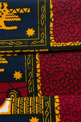 top view of red ankara fabric, flatlay of nigerian wax cloth with designs, spread out red ankara...