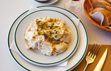 German salad, popular dish of Spanish cuisine. Salad with boiled potato, pickles, sausages and mayonnaise sauce