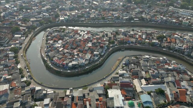 Dirty Canal Winds Through Tebet Neighborhood Jakarta Indonesia Drone Track Back 4K 60FPS