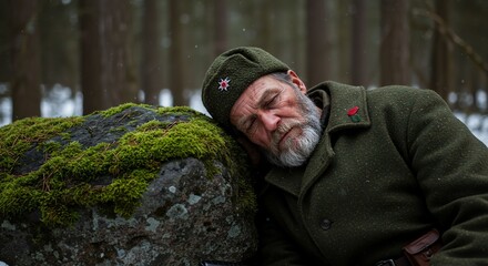Obraz premium Elderly Man Sleeping Resting Head on Mossy Rock in Forest Cold Weather