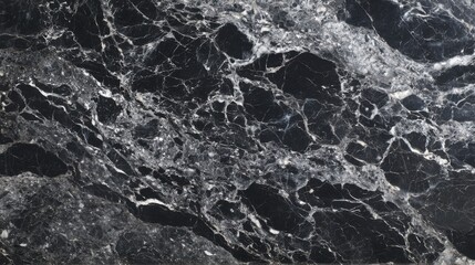 Richly textured black marble surface features intricate white veining that highlights the natural beauty of the stone, perfect for interior design and decoration projects.