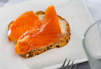 Buffet snack - canapes with delicate butter and pieces of bright pink salmon