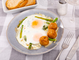 Appetizing breakfast with scrambled eggs, meatballs, asparagus