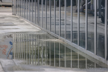June 29 2025 Reflective Urban Setting with a Modern Glass Exterior and Sidewalk