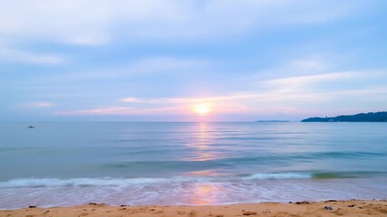 Beautiful sunset at the beach, peaceful ocean waves and clear skies