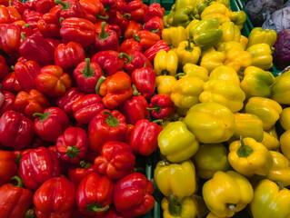 Colorful display of fresh red and yellow bell peppers arranged neatly in a market stall showcasing local produce and vibrant food choices