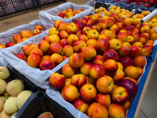 Fresh peaches and nectarines displayed in baskets at a local market during summer, showcasing vibrant colors and tempting textures for shoppers