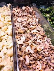 Assorted vegetables and mushrooms displayed in a market, highlighting fresh produce for healthy cooking options