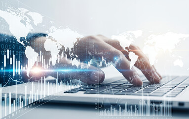 Hands typing on a laptop with a world map and graph overlay.