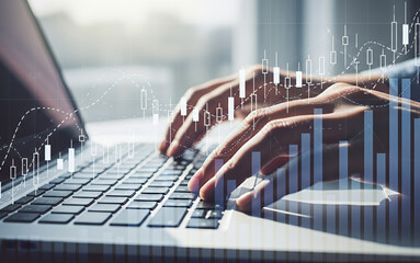 Hands typing on laptop with financial graph overlay business concept.