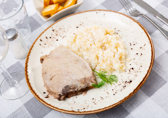 Image of tasty grilled tuna fillet with rice in interior of cafe