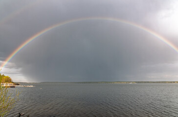 Rainbow over Blue lake with cloudy sky