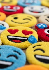 Textured assortment of colorful embroidered patches depicting popular digital communication icons and expressions