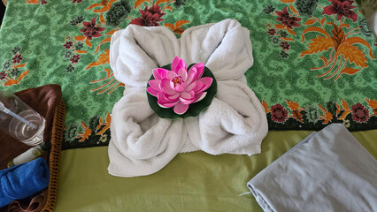 Spa massage bed with towel art and lotus flower