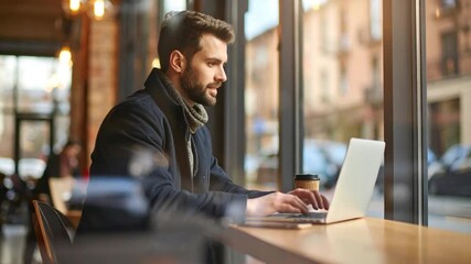 Man working on laptop in cafe - Powered by Adobe