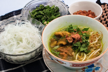 Soto contains meat, noodles and gravy. chicken Soto which is original from indonesian food isolated on white background
