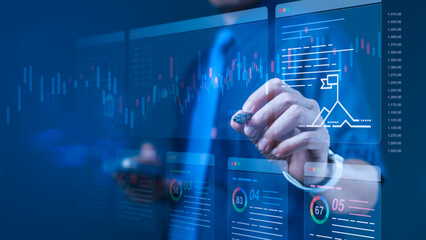 Businessman using stylus pen on virtual trading analytics screen for stock market strategy and investment planning tools