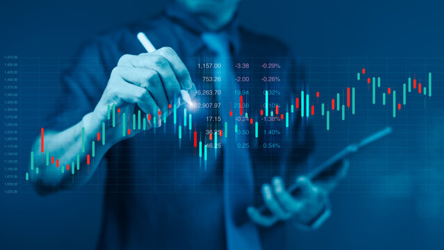 Businessman using stylus pen to analyze stock market chart on virtual screen for financial trading and investment data visualization - Powered by Adobe