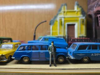 Miniature Scene of Man Standing Near Blue Soviet Car