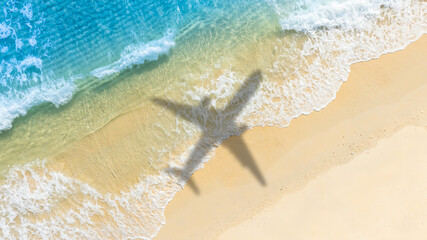 Aerial view of shadow passenger plane silhouette and sandy beach blue sea with waves at sea beach summer vacation sea travel concept	