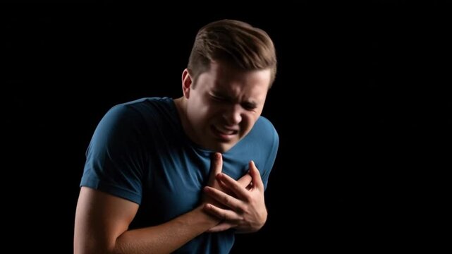 young man occures with a heart attact with serious expression in studio setting, 4k video, heart issues